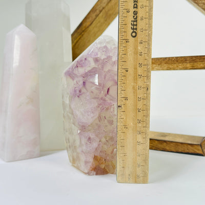 amethyst point next to a ruler for size reference