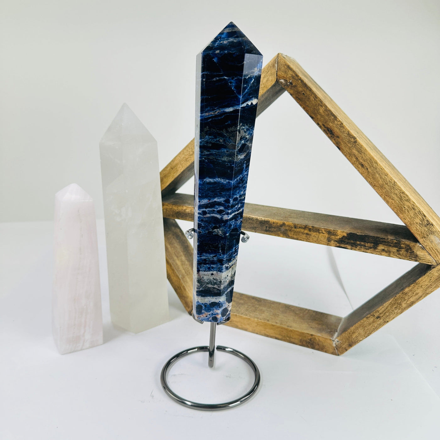 sodalite point with decorations in the background