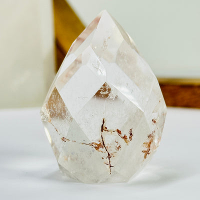 crystal quartz point with decorations in the background