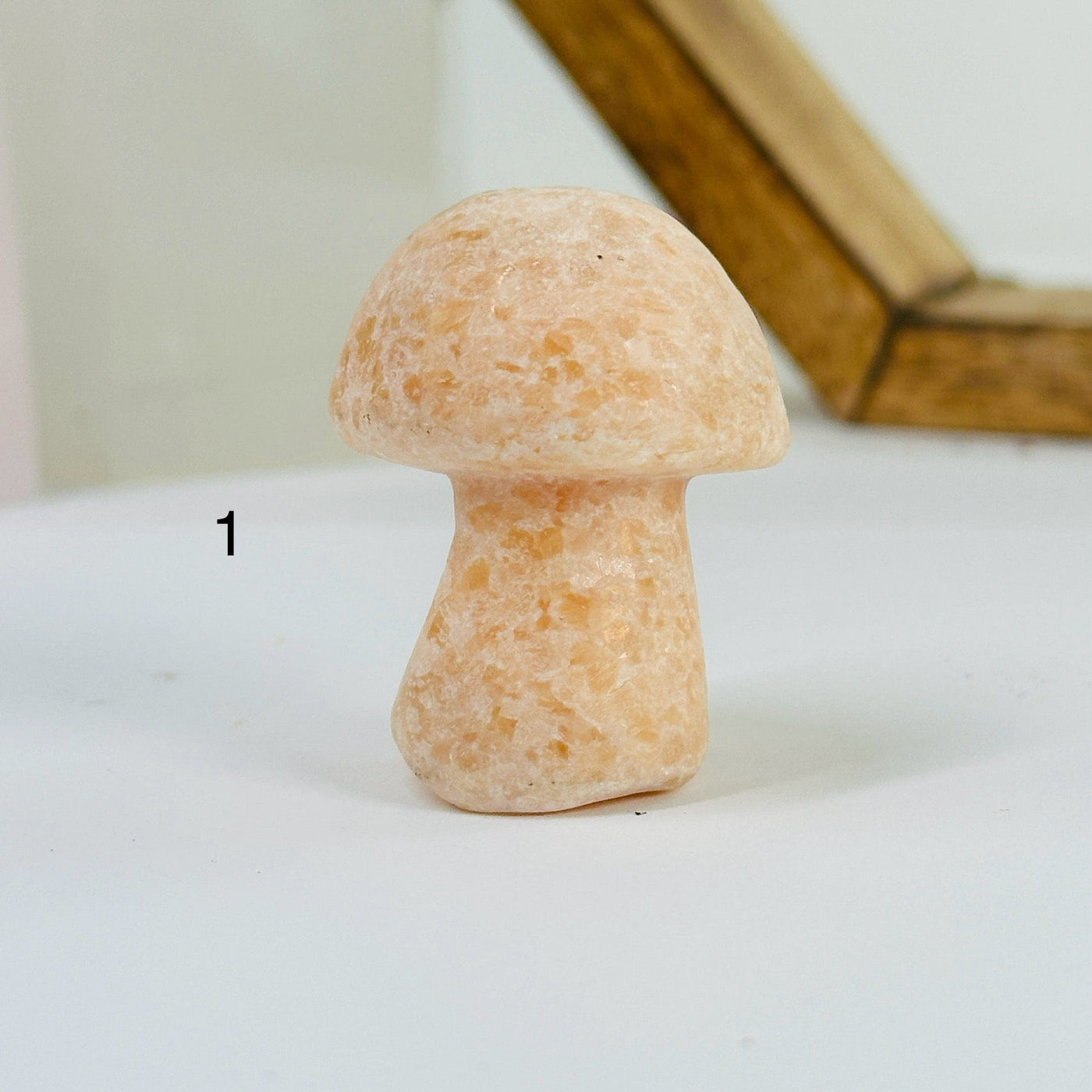 peach calcite mushroom with decorations in the background