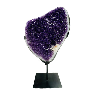 amethyst on metal stand on white background
