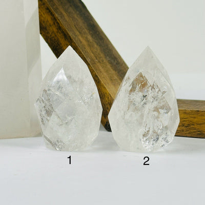 crystal quartz point with decorations in the background