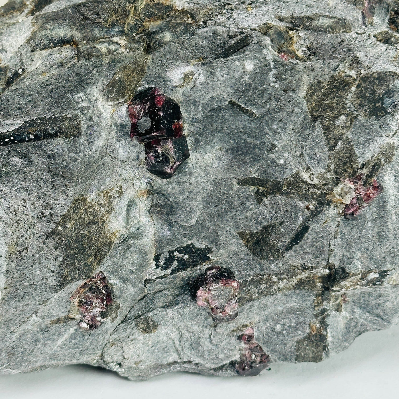 garnet on hematite with decorations in the background