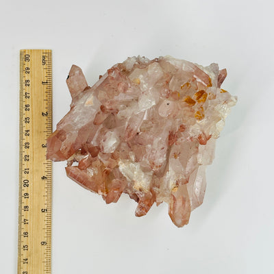 lithium quartz cluster next to a ruler for size reference