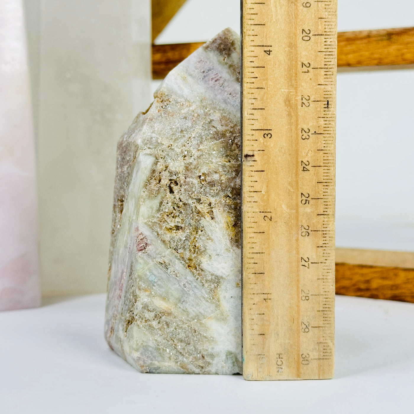 tourmaline point next to a ruler for size reference