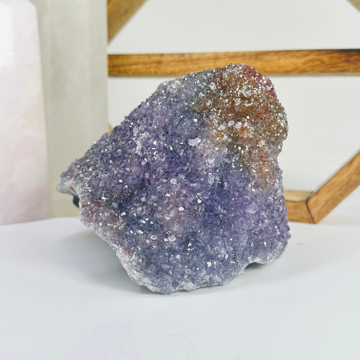 amethyst cluster with decorations in the background