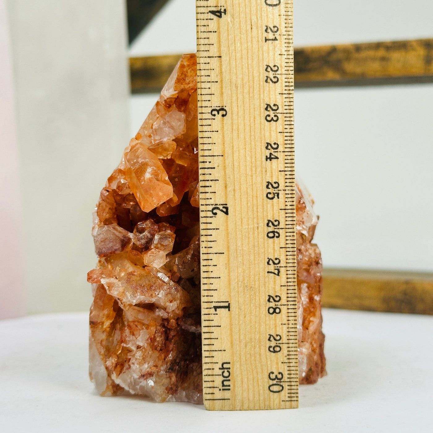 tangerine quartz points next to a ruler for size reference