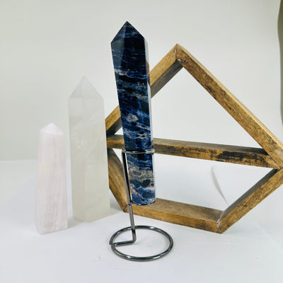 sodalite point with decorations in the background