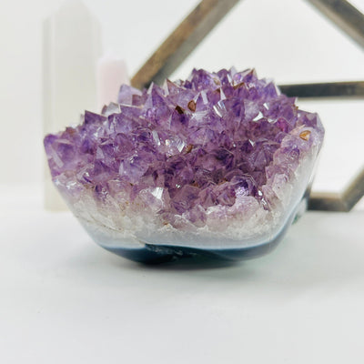 amethyst cluster with decorations in the background