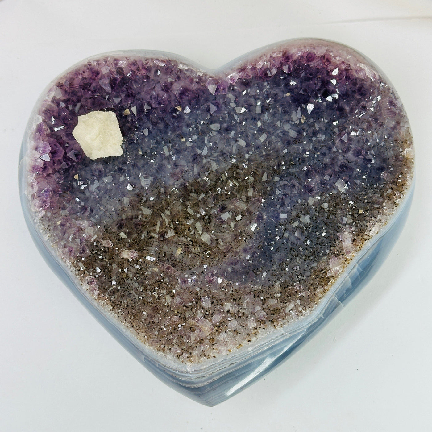 amethyst heart with decorations in the background