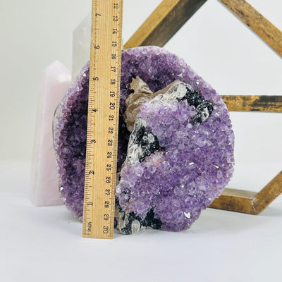 amethyst cutbase next to a ruler for size reference