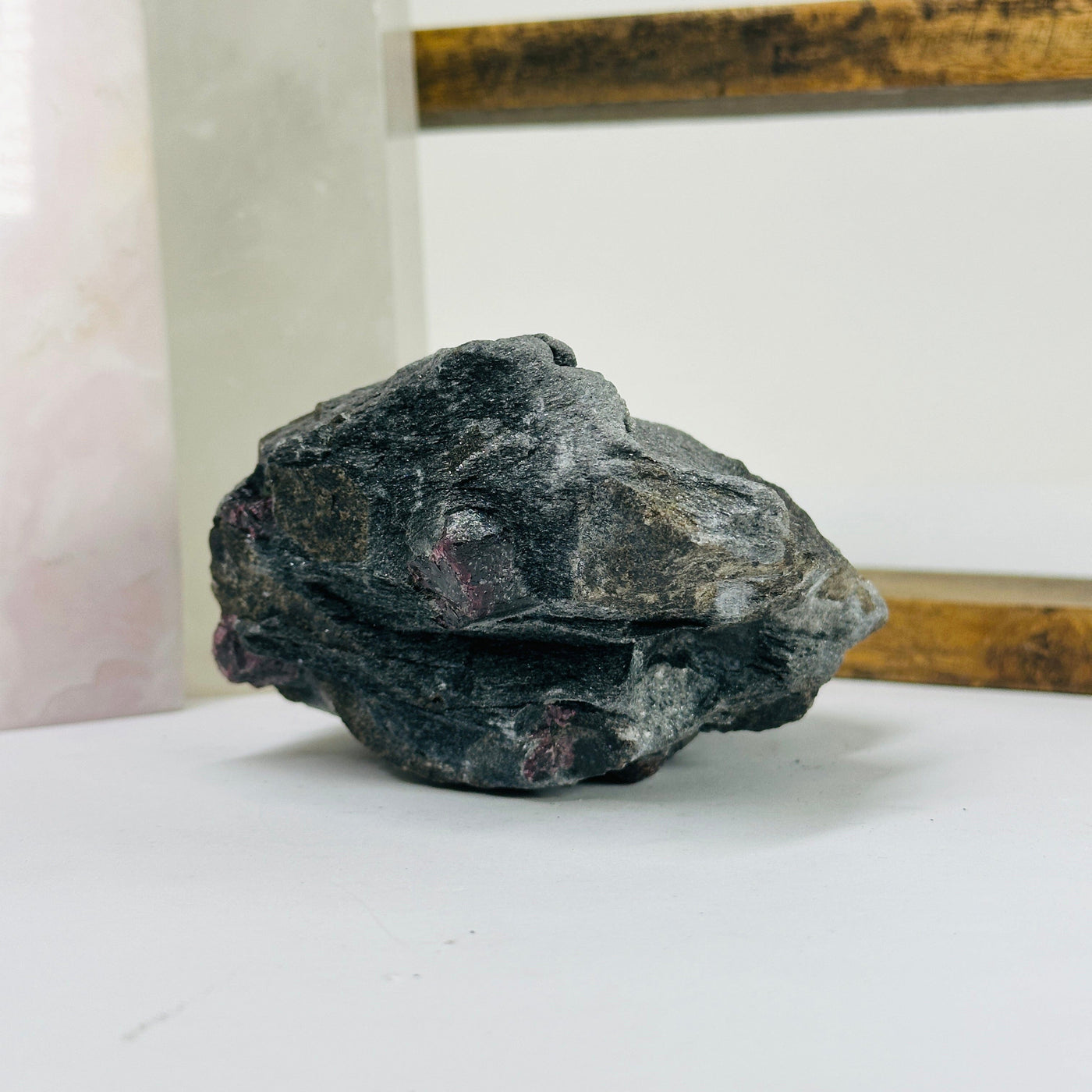 garnet on hematite matrix with decorations in the background