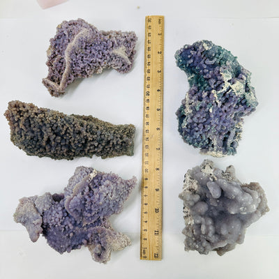 grape agate next to a ruler for size reference