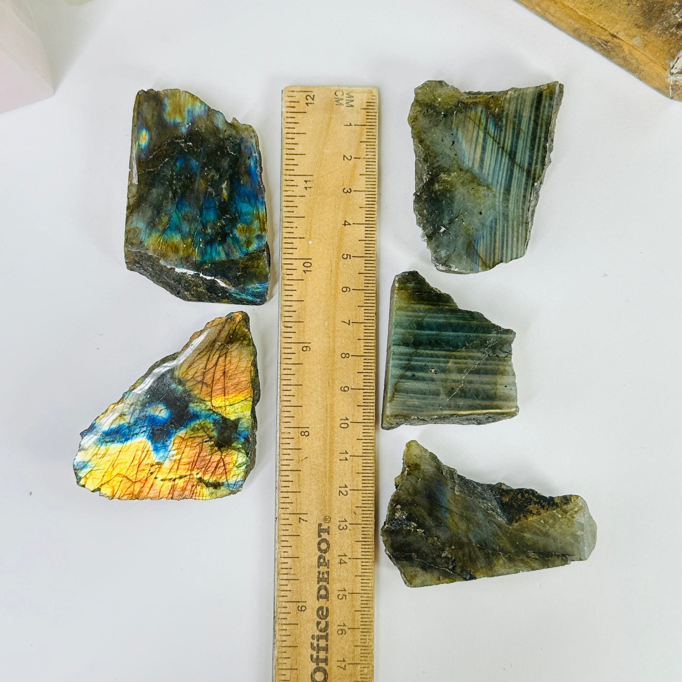 labradorite next to a ruler for size reference