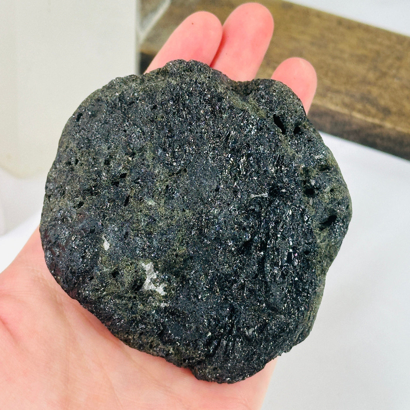 tourmaline cluster with decorations in the background