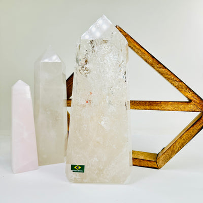 crystal quartz point with decorations in the background