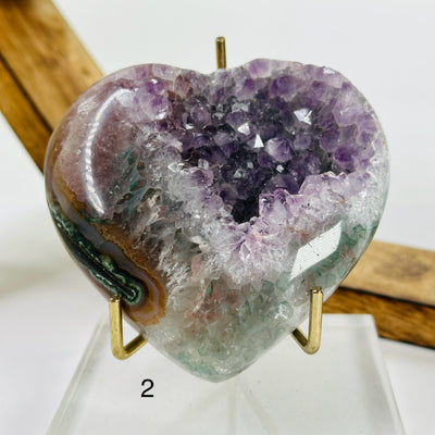 amethyst heart with decorations in the background