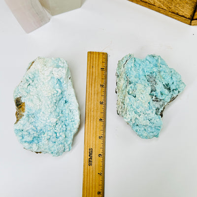 aragonite next to a ruler for size reference