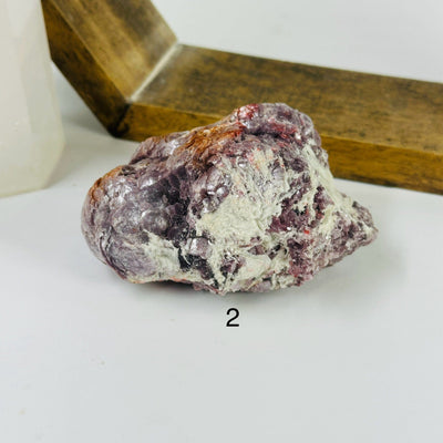 lepidolite cluster with decorations in the background