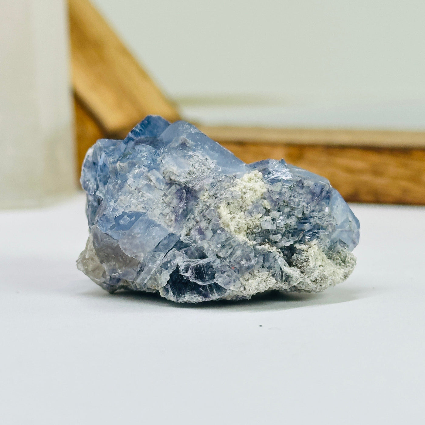 blue fluorite with decorations in the background