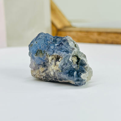 blue fluorite with decorations in the background