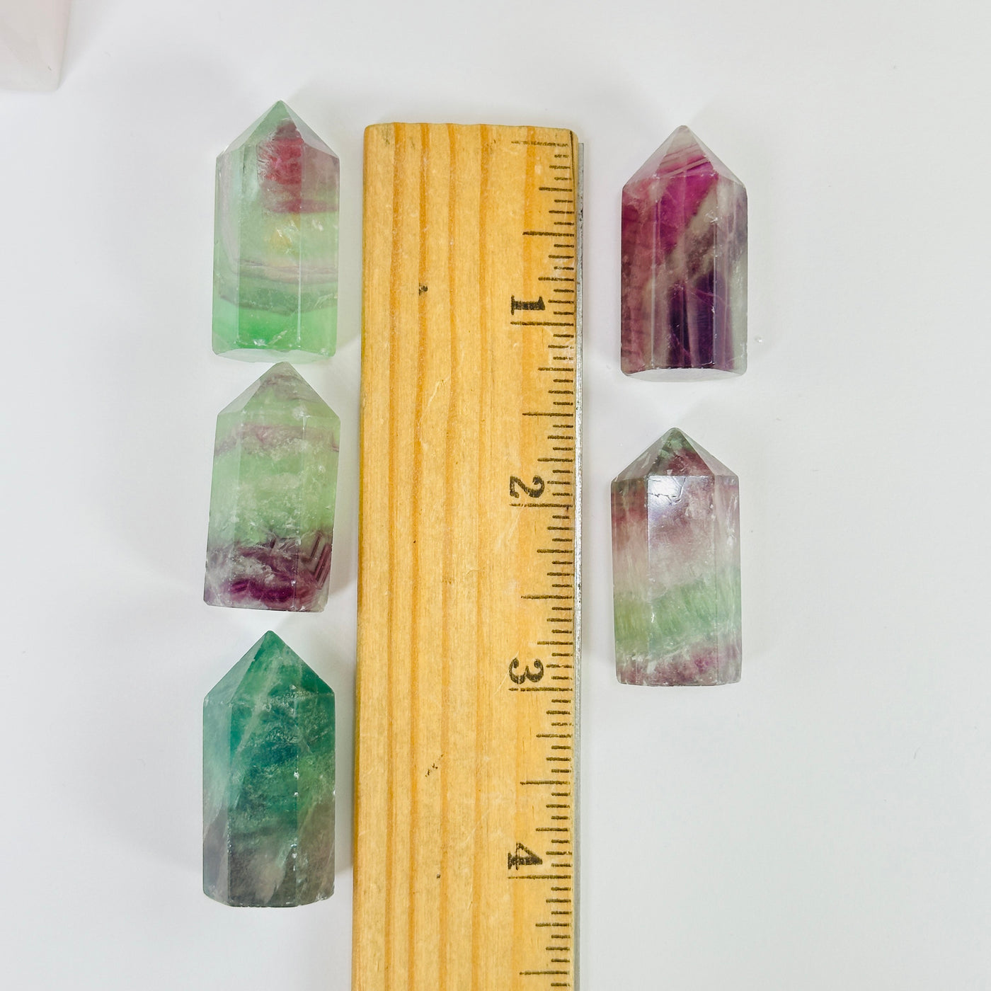 fluorite points next to a ruler for size reference