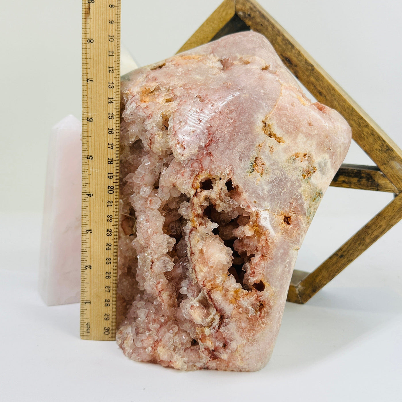 pink amethyst next to a ruler for size reference