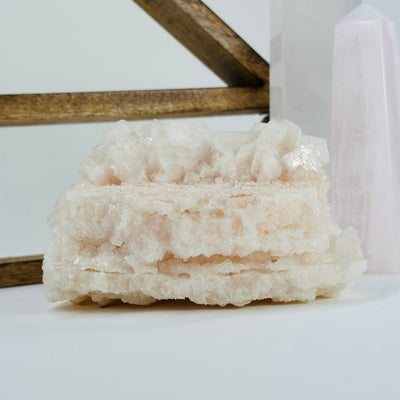 pink halite cluster with decorations in the background