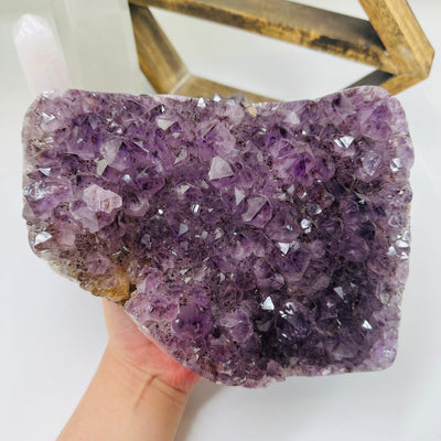 amethyst cluster with decorations in the background