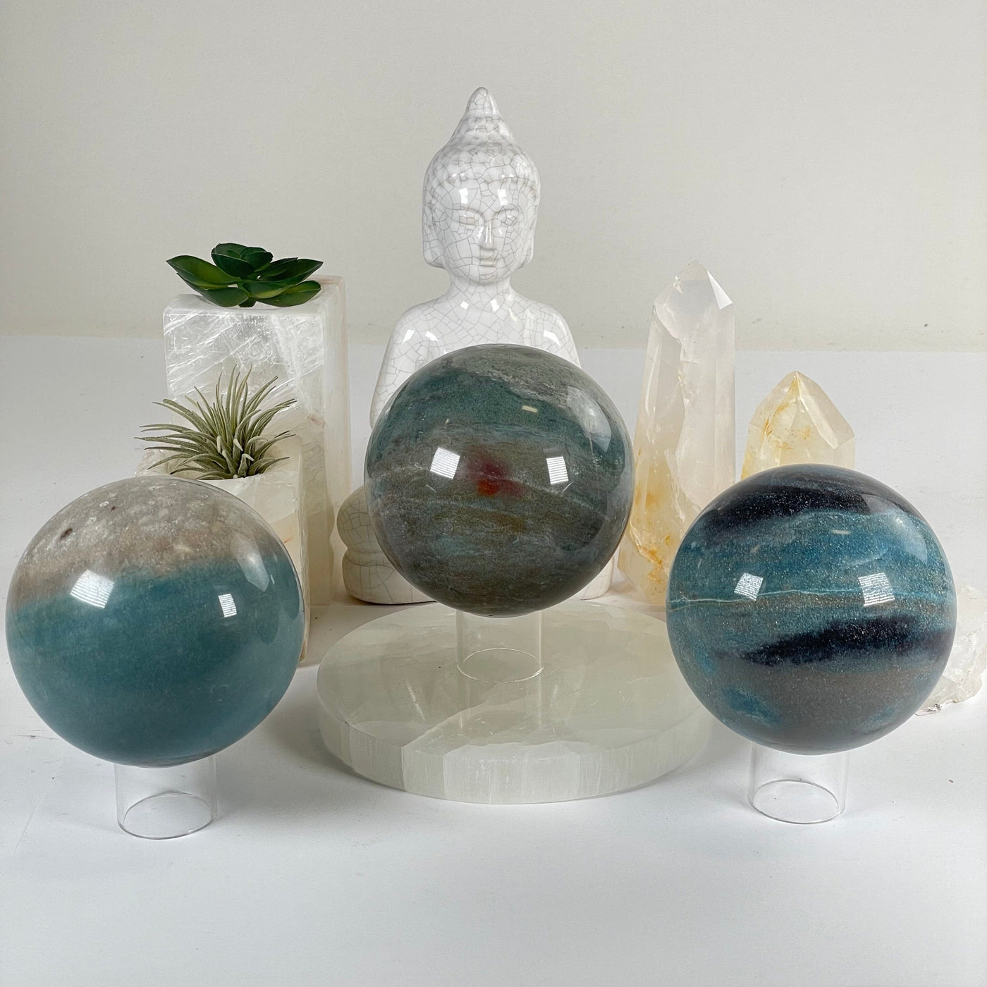 Trolleite Large Crystal Sphere - You Choose #2 all variants front view with props and plants in the background