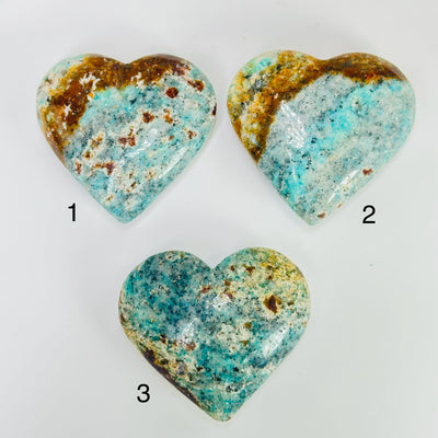 amazonite heart with decorations in the background