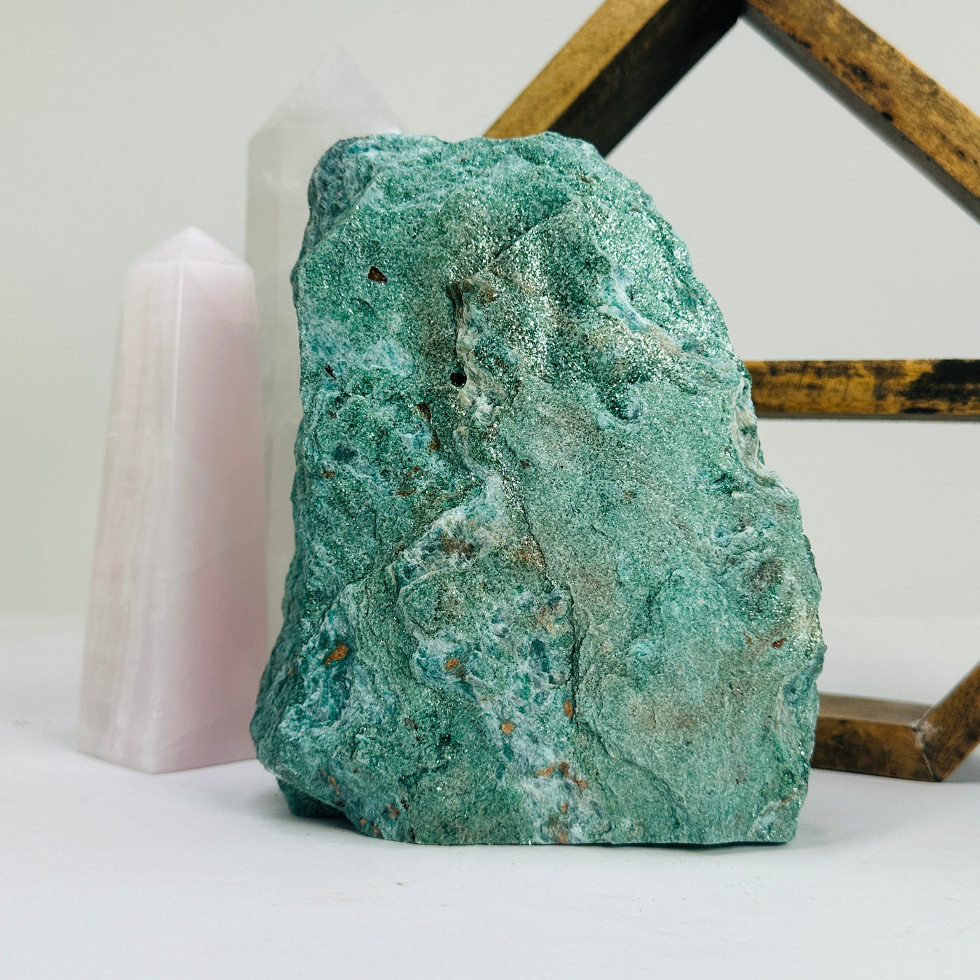 fuchsite cut base with decorations in the background