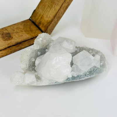 zeolite with apophyllite with decorations in the background