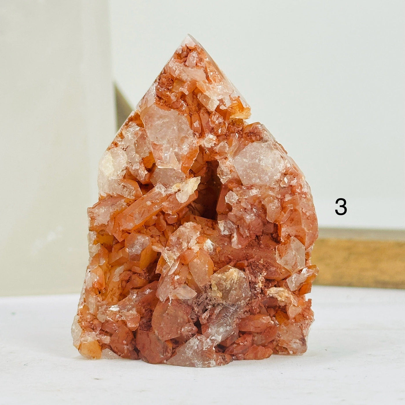 tangerine quartz points with decorations in the background