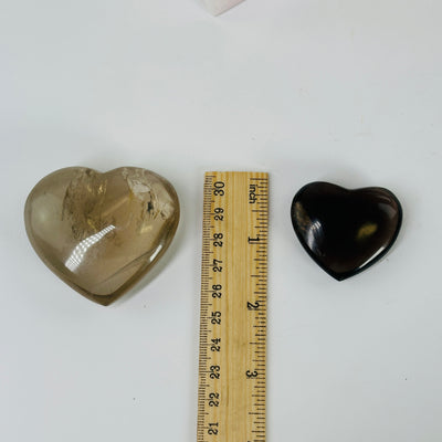 smoky quartz heart next to a ruler for size reference