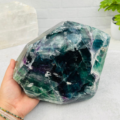 Large Tumbled Rainbow Fluorite Crystal in hand for size reference 