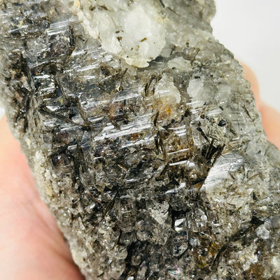 smokey rutile quartz with decorations in the background