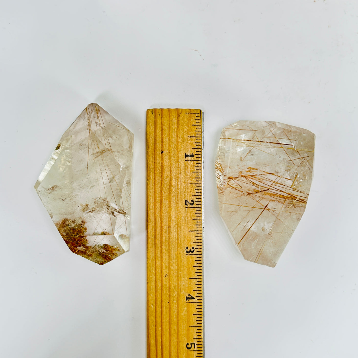 rutile quartz next to a ruler for size reference