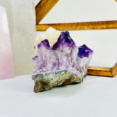 amethyst cut base with decorations in the background