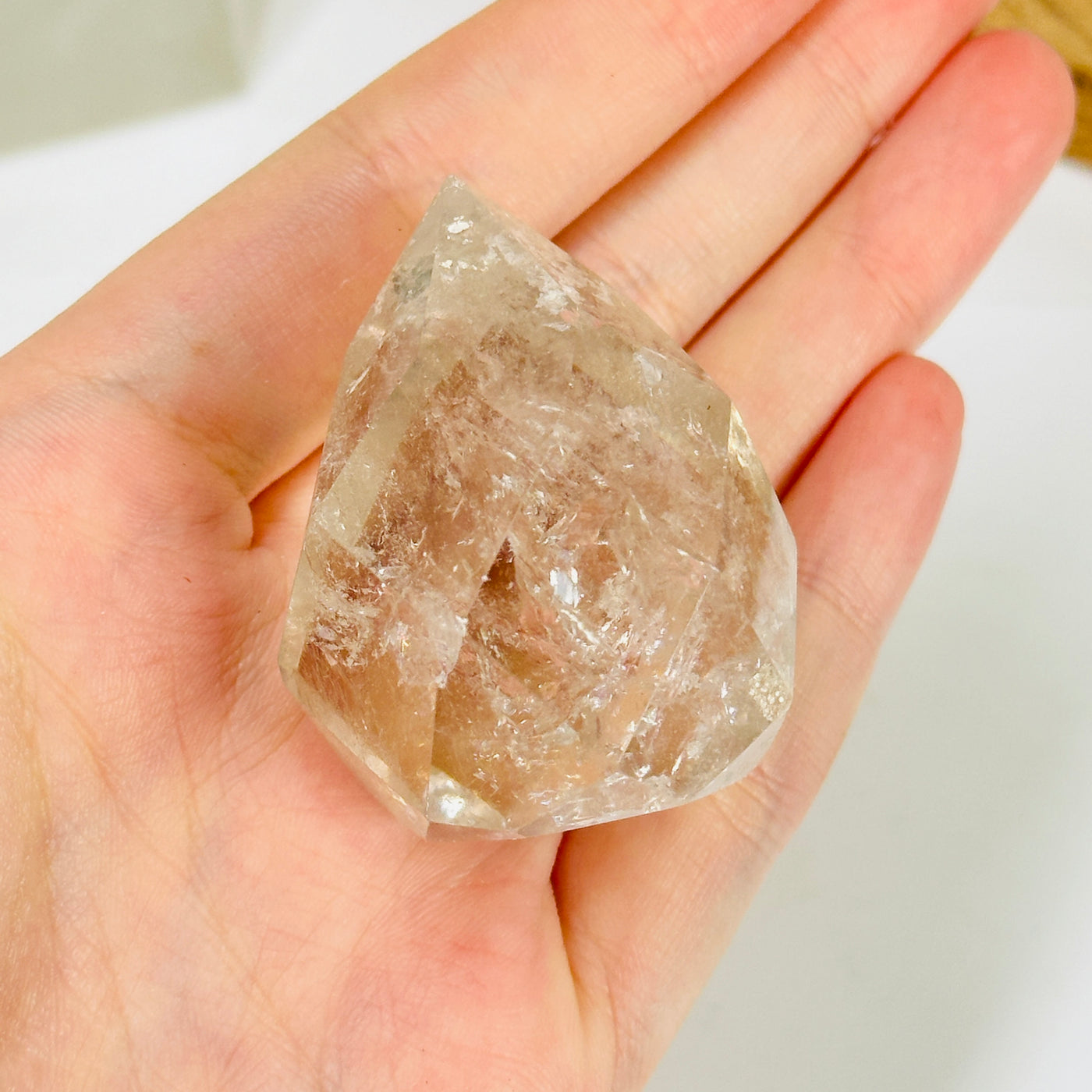 crystal quartz point with decorations in the background