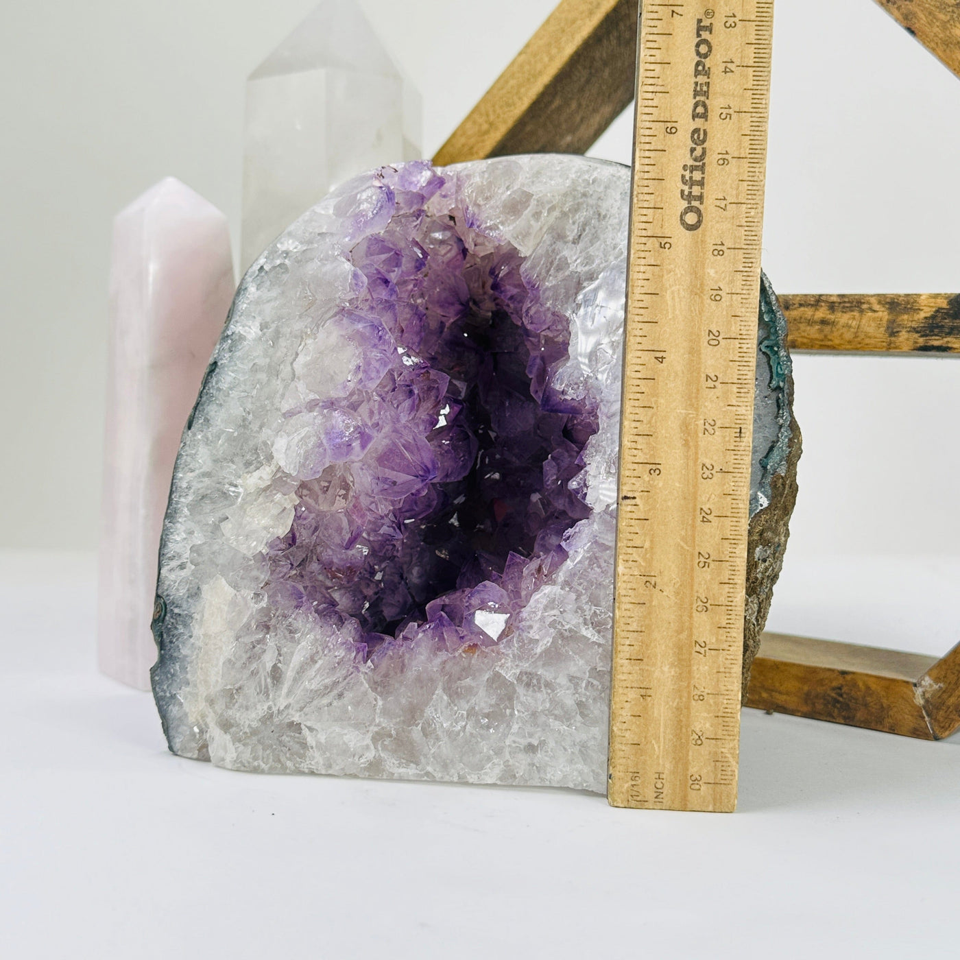 amethyst geode next to a ruler for size reference