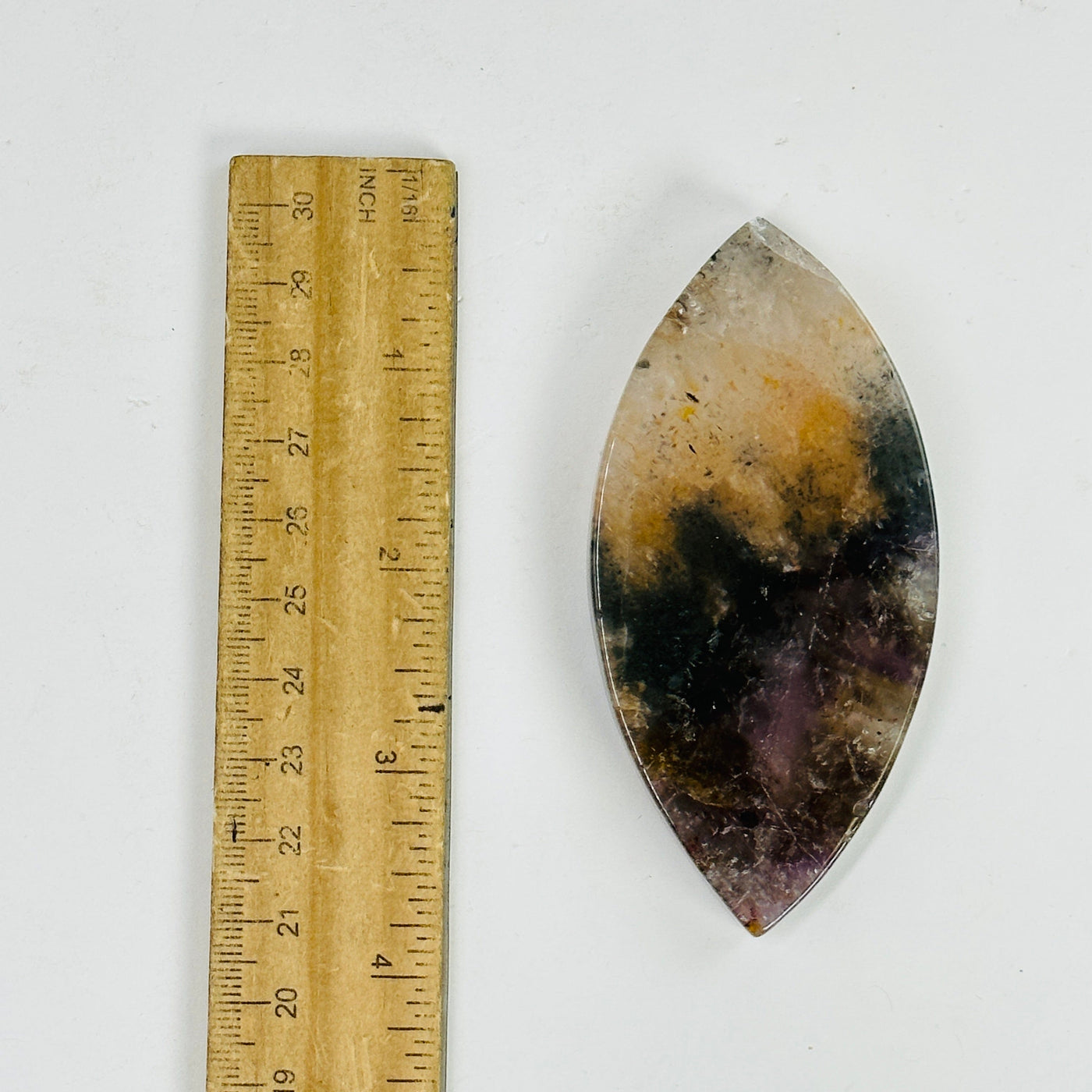 super seven stone marquise next to a ruler for size reference