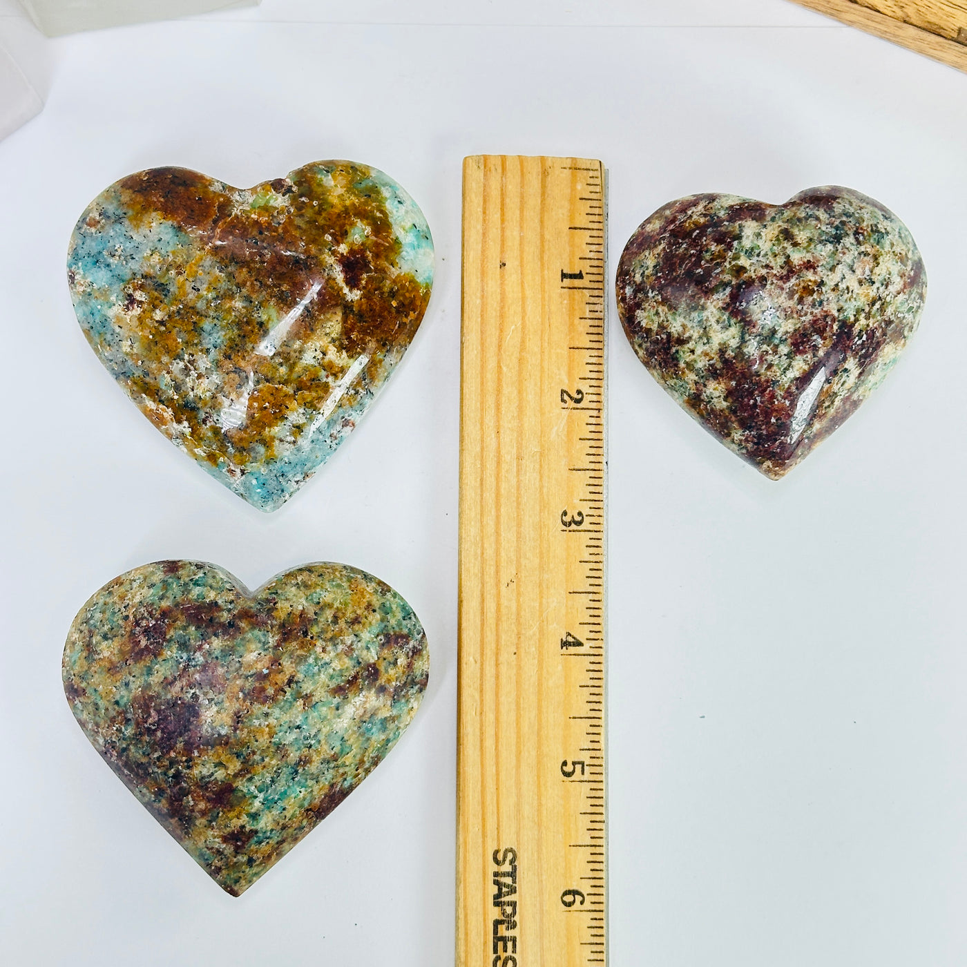 amazonite heart next to a ruler for size reference