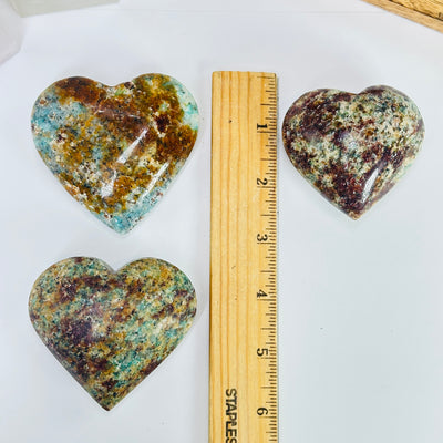 amazonite heart next to a ruler for size reference