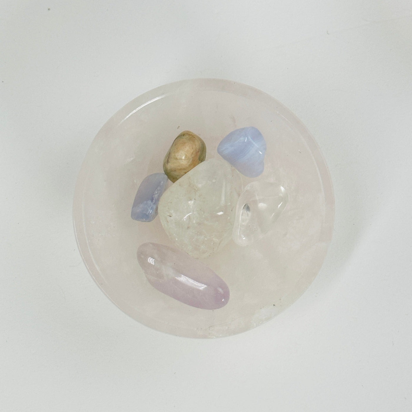 mini rose quartz bowl holding other crystals in it