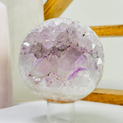 amethyst sphere with decorations in the background