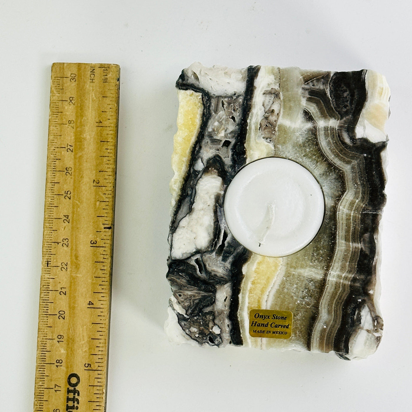 Mexican onyx candle holder next to a ruler for size reference