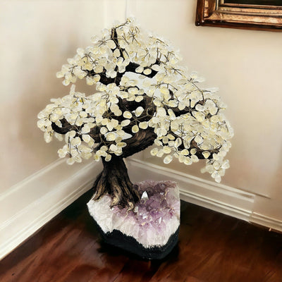 crystal quartz tree on amethyst stand with decorations in the background