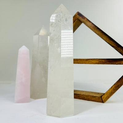 crystal quartz point with decorations in the background