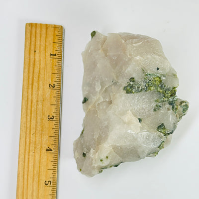 tourmaline next to a ruler for size reference